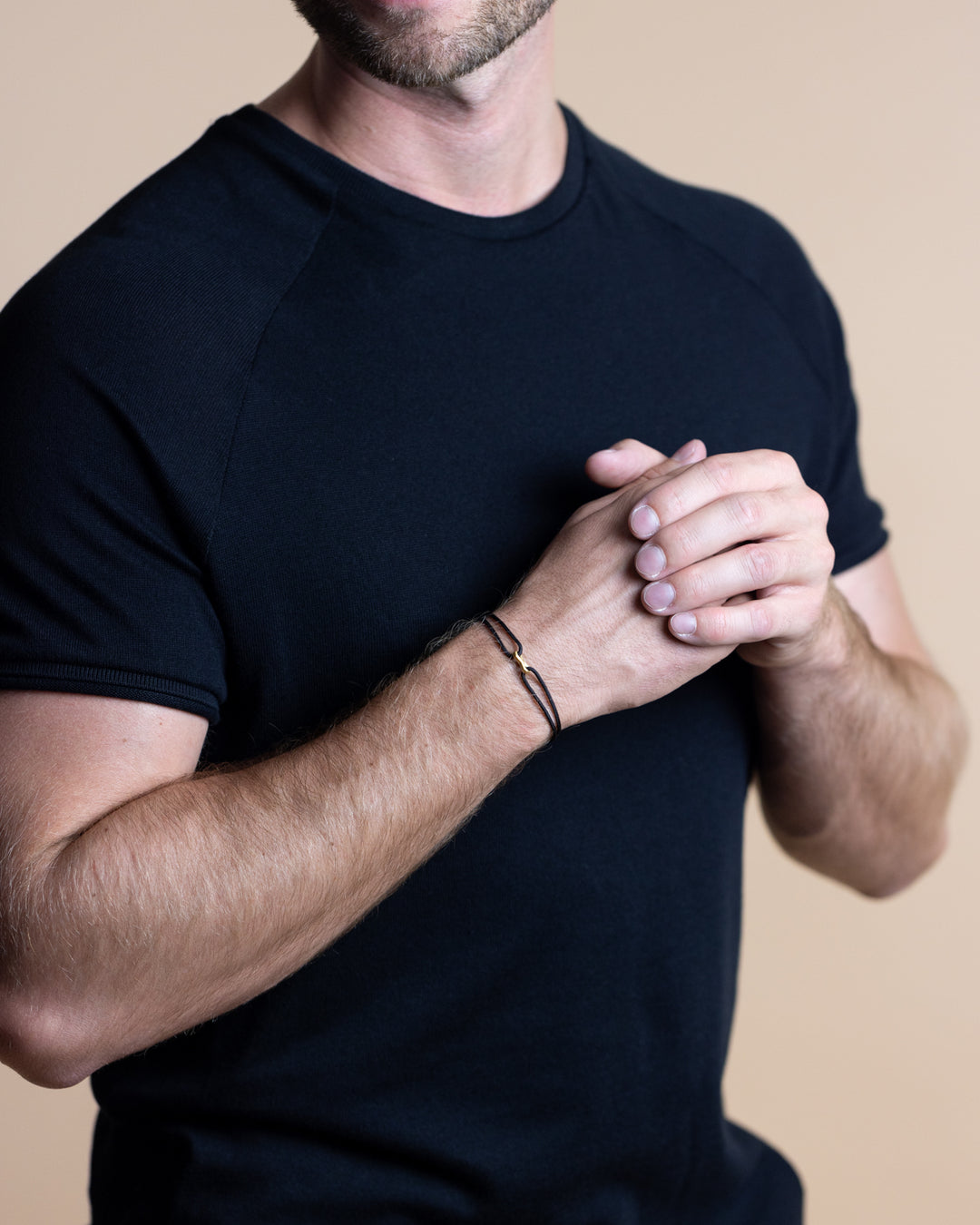 Black nylon bracelet with a gold-plated infinity sign