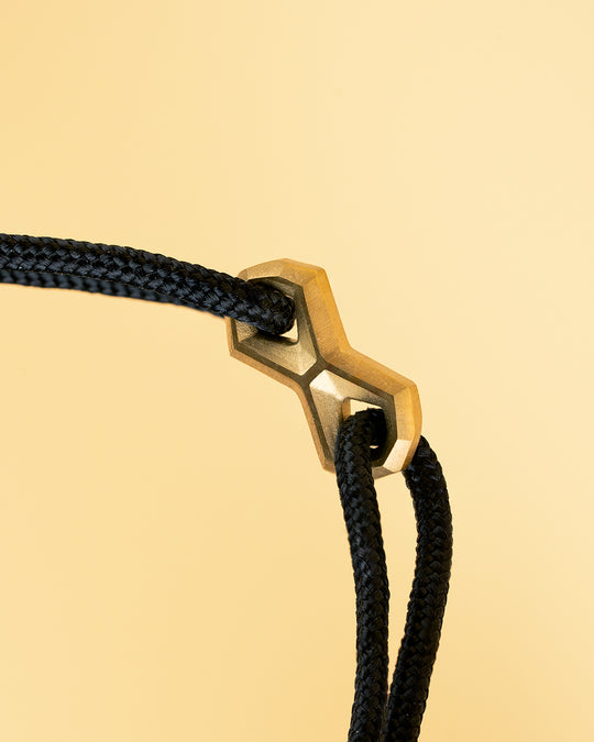 Black nylon bracelet with a gold-plated infinity sign