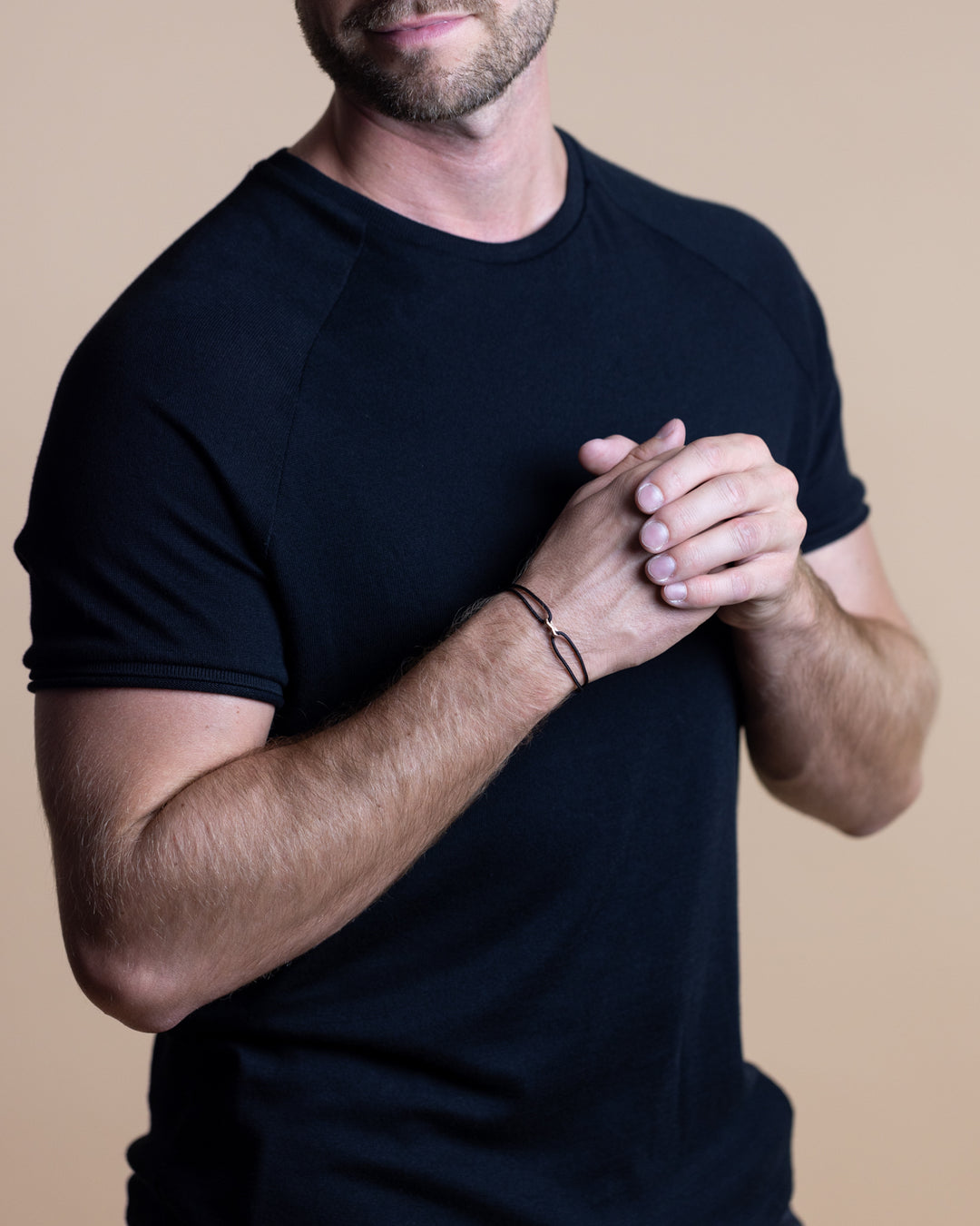 Black nylon bracelet with a bronze-plated infinity sign