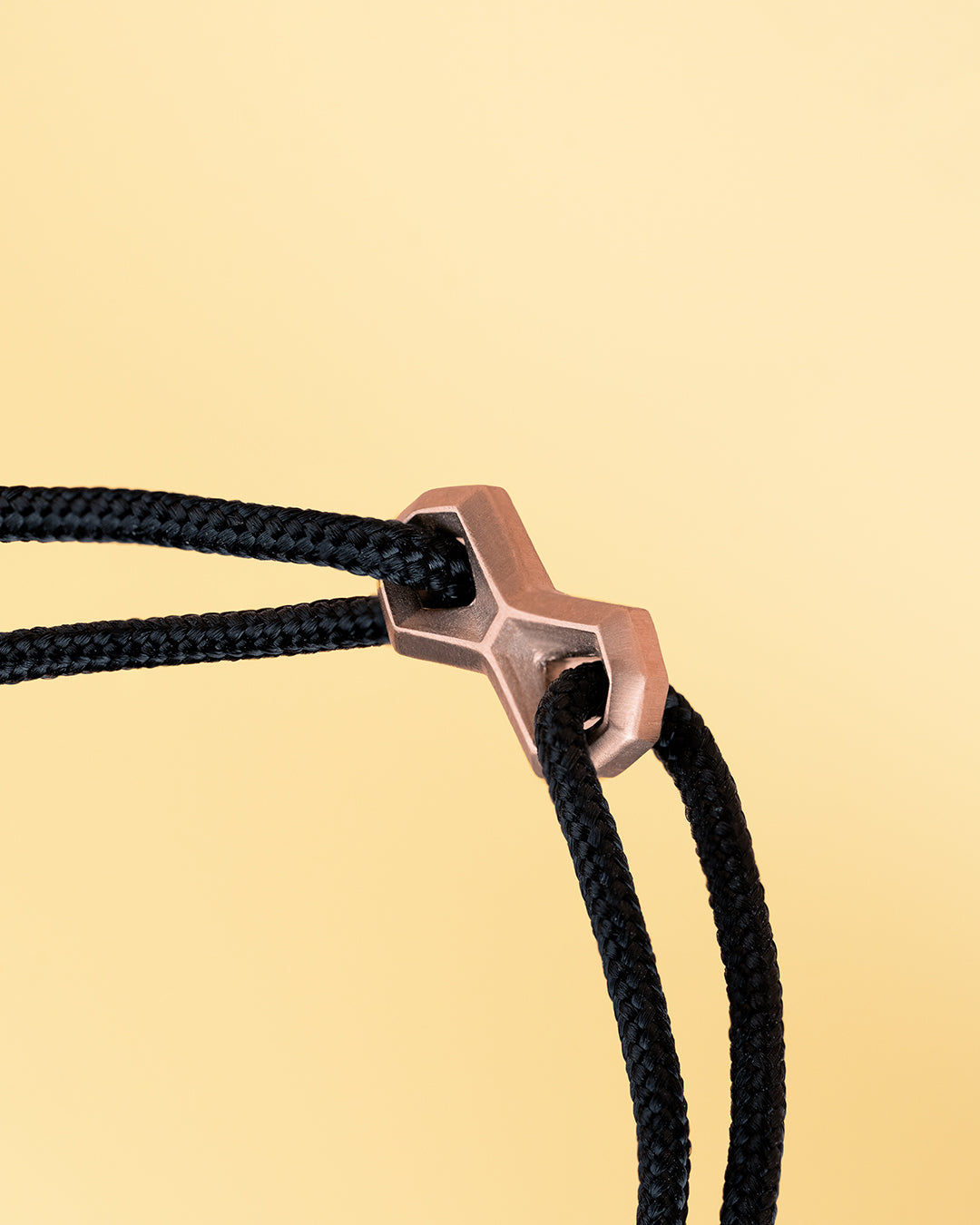 Black nylon bracelet with a bronze-plated infinity sign