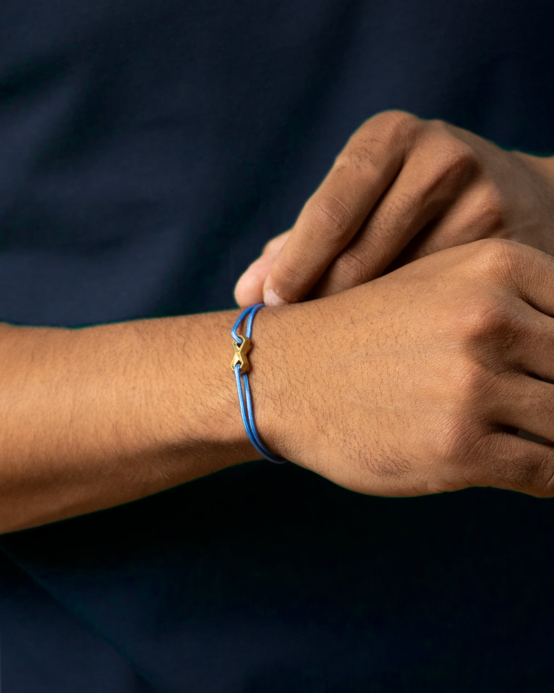 Light blue nylon bracelet with a titanium infinity sign