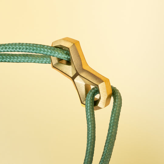 Green nylon bracelet with a titanium Infinity sign