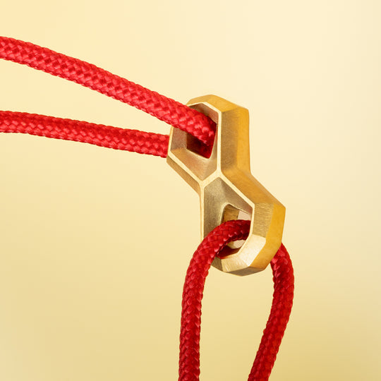 Red nylon bracelet with a titanium infinity sign