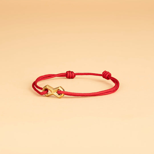 Red nylon bracelet with a titanium infinity sign