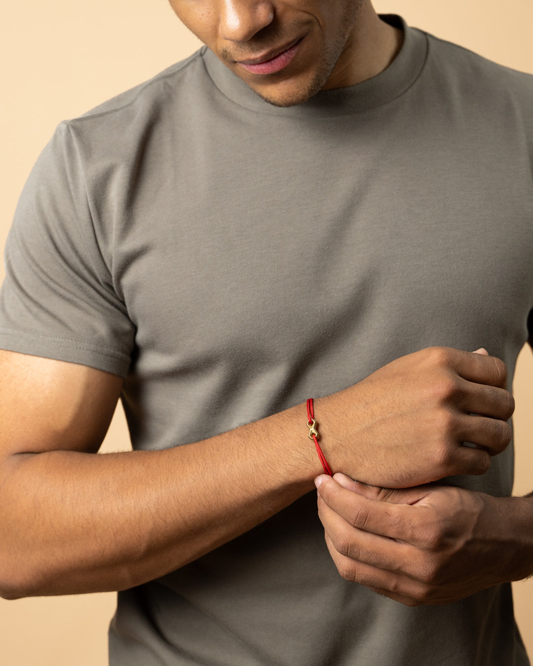 Red nylon bracelet with a titanium infinity sign