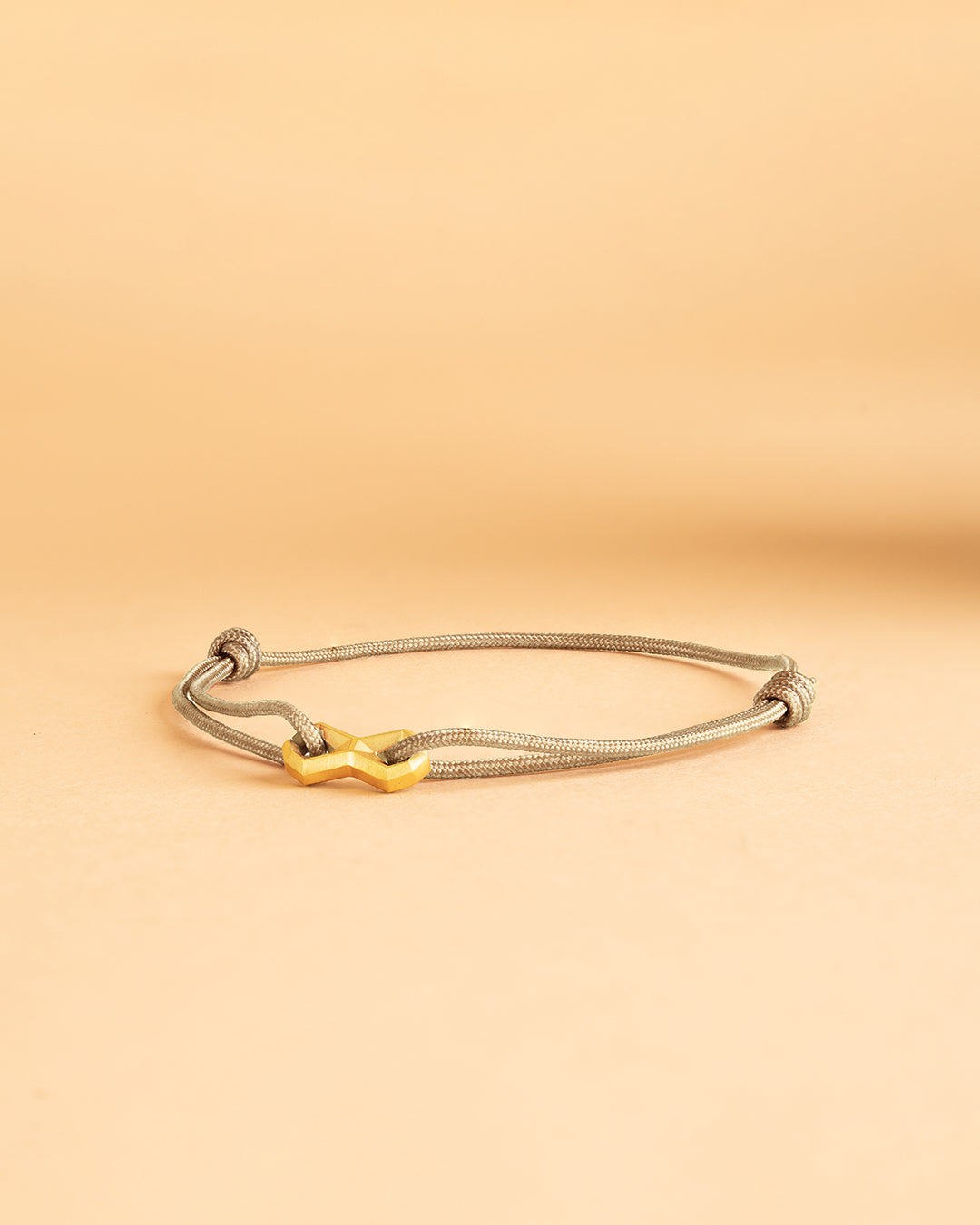 1.5mm Beige nylon bracelet with a titanium Infinity sign