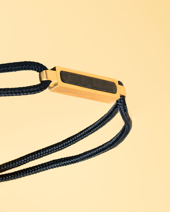 Black nylon bracelet with a gold-plated carbon element