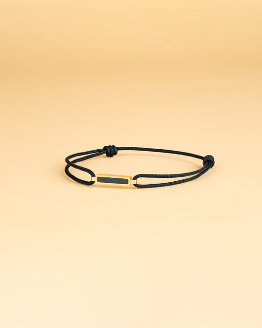 Black nylon bracelet with a gold-plated carbon element