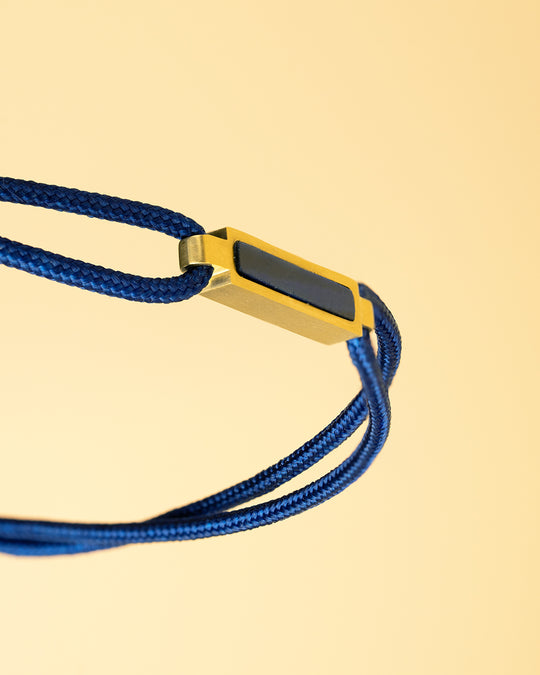 Blue nylon bracelet with a gold-plated Blue Tiger Eye element
