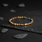 Bracelet with 6mm matte Tiger Eye stone and titanium element