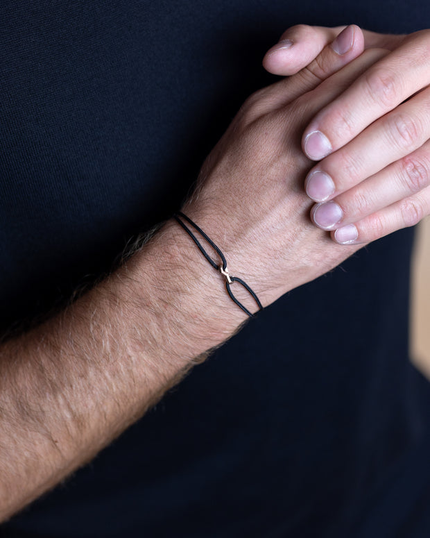 1,5 mm zwarte nylon armband met een bronskleurig Infinity-teken