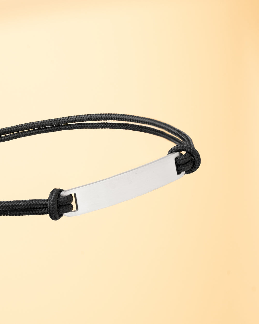 1.5mm black nylon bracelet with a silver stainless steel closing and engraving plate